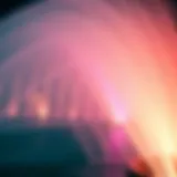 A close-up view of the Dubai Fountain's water jets in action, illuminated with colorful lights at night